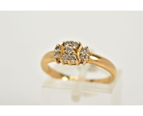 A YELLOW METAL DIAMOND RING, designed with a central panel set with nine round brilliant cut diamonds, plain polished band, s