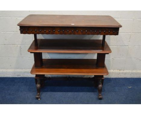 AN EARLY VICTORIAN MAHOGANY TELESCOPIC THREE TIER BUFFET, with a lappet carved frieze with roundels to the top tier concealin
