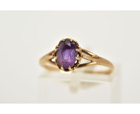 A 9CT GOLD AMETHYST RING, designed with a claw set oval cut amethyst, trifurcated shoulders, hallmarked 9ct gold Edinburgh, r