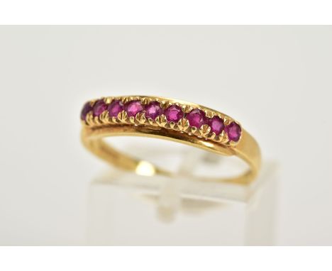 AN 18CT GOLD RUBY HALF HOOP RING, designed with row of claw set circular cut rubies, plain polished band hallmarked 18ct gold