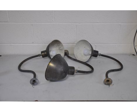 THREE EARLY TO MID 20TH CENTURY WALL/PICTURE LIGHTS with copper domed shades and swan neck stems and brass fittings, there is