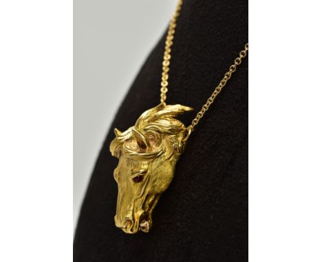 A MODERN HORSE HEAD PENDANT, realistically stylized, textured finish with ruby eyes, pendant measuring approximately 36.0mm x