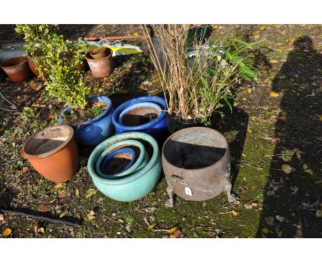 SEVEN MODERN GLAZED PLANT POT'S AND A TINPLATE CAULDREN with plants in two, the largest green planter is 46cm in diameter (9)