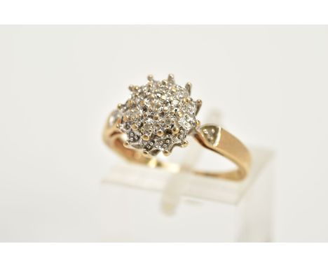 A 9CT GOLD DIAMOND CLUSTER RING, the tiered cluster set with single cut diamonds, single cut diamond detailed shoulders, stam