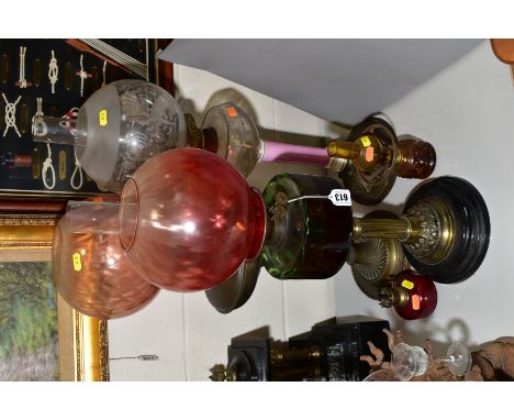 FIVE VARIOUS VICTORIAN/EDWARDIAN OIL LAMPS, including an example with frosted and clear globe shade, clear reservoir, pink gl