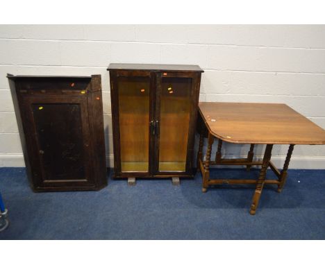 A 20TH CENTURY OAK BARLEY TWIST GATE LEG DINING TABLE, together with a stained pine glazed double door bookcase and a Georgia