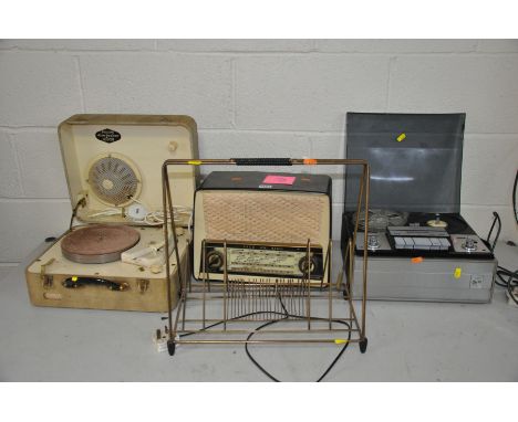 THREE VINTAGE MUSIC PLAYERS AND A 1950'S RECORD RACK, including an Ekco U.319 Valve radio, a Marconiphone Reel to Reel Player