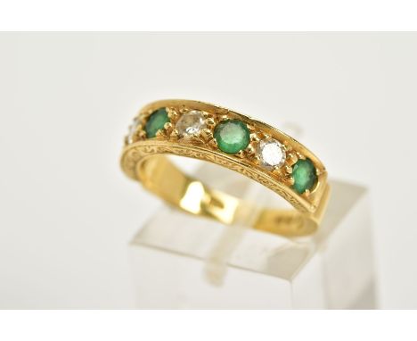 AN 18CT GOLD EMERALD AND DIAMOND HALF HOOP RING, designed with four claw set emeralds interspaced with three round brilliant 