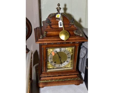 AN EARLY 20TH CENTURY GERMAN WALNUT CASED BRACKET CLOCK, the caddy hood with gilt metal mounts, gilt dial, silvered chapter r