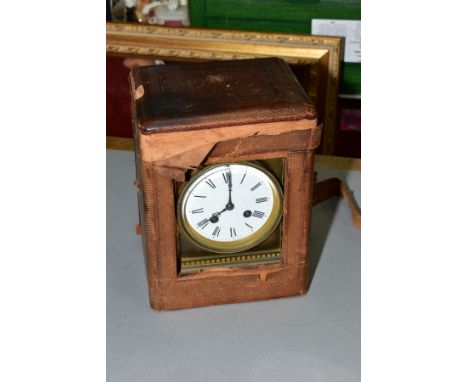 A LATE 19TH CENTURY BRASS MANTEL CLOCK WITH FITTED TRAVELLING CASE, hinged handle to the top, circular enamel dial, Roman num