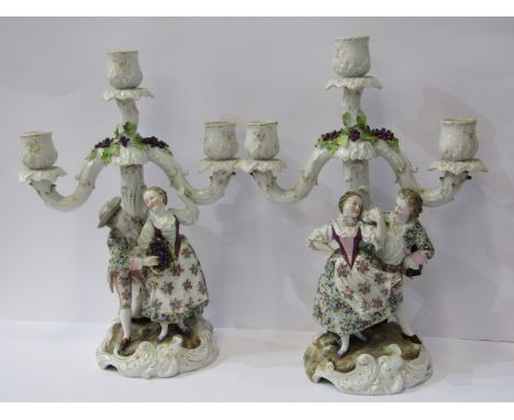 CONTINENTAL PORCELAIN, pair of 19th Century figure based and encrusted triple sconce candelabra, 30cm height 