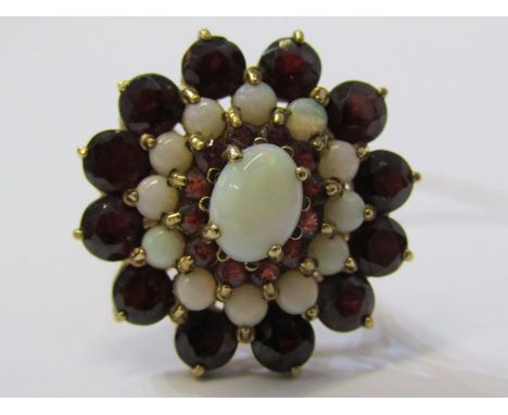 IMPRESSIVE 9ct YELLOW GOLD GARNET &amp; OPAL CLUSTER RING, principal oval cut opal surrounded by a halo of small brilliant cu