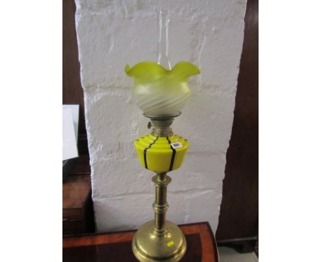 EDWARDIAN OIL LAMP, circular brass based oil lamp with opaque yellow glass reservoir and shade 74cms high 