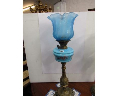 OIL LAMP, ornate brass based oil lamp with painted blue glass reservoir and frosted blue crinoline shade 