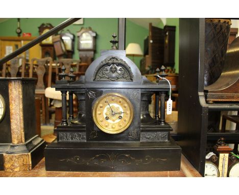 A large Victorian black slate mantle Clock with gilded dial Arabic numerals, dome top, carved pillars and panels, 15" long x 