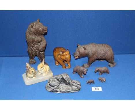 A family of Black Forest wooden bears, a carved elephant, pair of small ceramic rabbits on onyx plinth and a model of large h