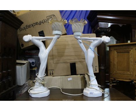 A pair of white ceramic Art Deco style lamps in the form of ladies, with fluted glass shades, some crazing 24" tall.