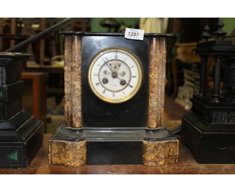 A slate and polished stone Mantle Clock by Henry Marc, Paris, having open work face with Roman numerals, key and pendulum pre