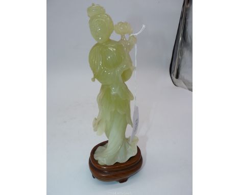 A Jade coloured sculpture of an oriental Geisha figuer in a swirling dress and holding a flower aloft in her right hand, comp