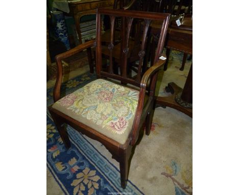 An elegant Georgian Mahogany open armed corner/elbow Chair having stylised floral bosses to the backrest, the drop-in seat ni