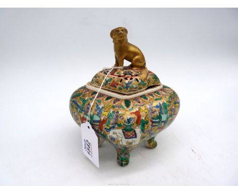 An Oriental diamond shaped footed and lidded pot with scenes of Elephants and sages with papers at tables with Dog of Fo to t