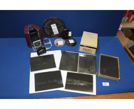 A box containing a box of old glass photographic plates and four cine movies- Redskin Raiders, Disney's lovesick Pluto, Minni