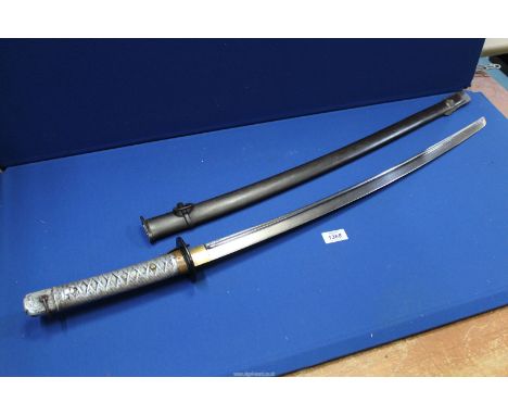 A WWII Japanese Non Commissioned Officer's Sword, with iron scabbard, impressed number 150172 to the 67 cm long blade. Overal
