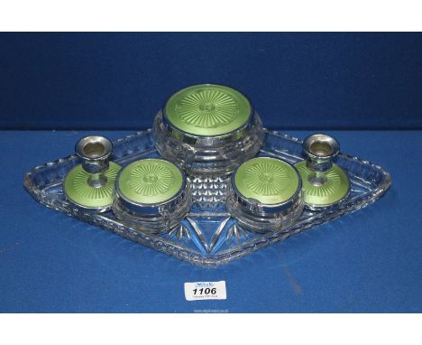 A vintage six piece dressing table set in green comprising three lidded jars, plain candlesticks and glass tray.