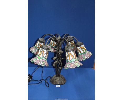 A six branch floral Tiffany style Lamp with entwined leaf base, 18 3/4'' tall.