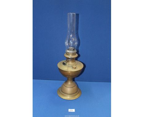 A brass oil lamp with glass chimney, 22 1/4" tall overall.