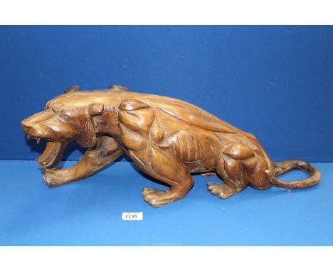 A large carved model of a Tiger, 23" x 8".