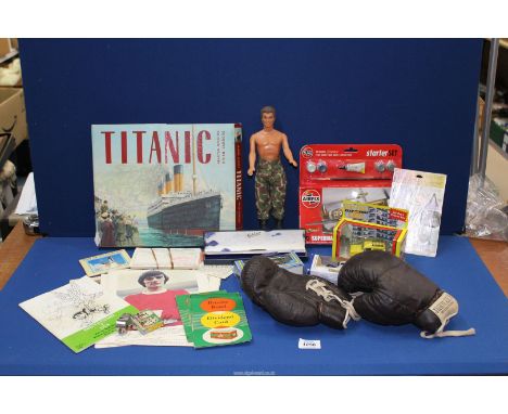 A quantity of miscellanea to include; boxed model cars, a pair of small Jubilee's International boxing gloves, Airfix, Spitfi