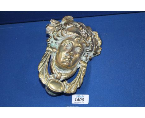 A brass Door Knocker in the form of a Grecian lady's head.