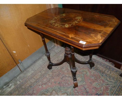 An imposing Rosewood and other woods occasional Table, the top with lightwood stringing and a centre feature with shields and