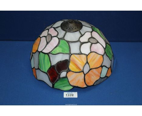A Tiffany style lamp shade in mauve, orange, green and grey floral design, 10" diameter.