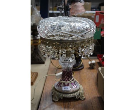A very heavy glass lamp having pressed glass base with purple highlights and droppers on the shade, 16" tall including shade.