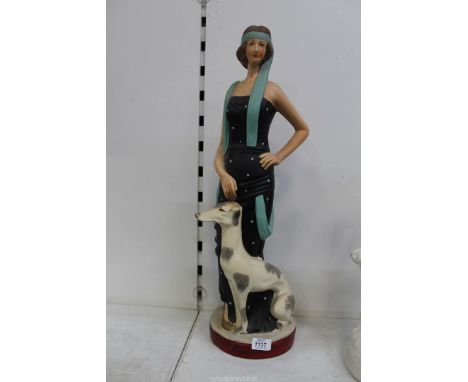 A ceramic figure of a 1920's lady with a greyhound, 25 1/4" tall.