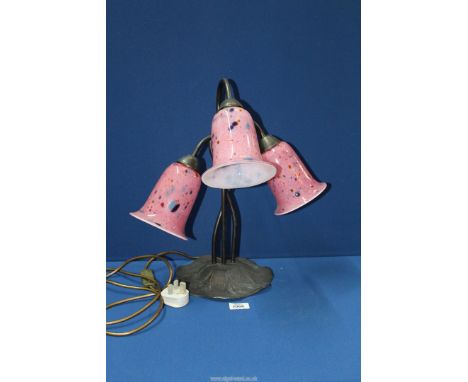 A three branch Lily shaped table lamp with pink and multicoloured mottled glass shades on a cast metal Lily pad base, 17 1/2'