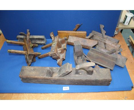 A quantity of vintage woodworking planes including coffin planes.