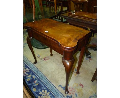 An elegant Mahogany and Walnut swivel top flap-over Card Table having a veneered mirrored shaped top opening to reveal a gree