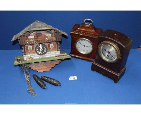Two wooden Mantle clocks and a Cuckoo clock with weights.