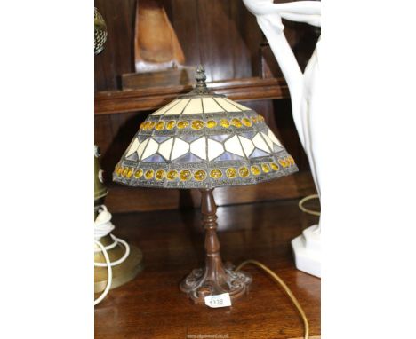 A Tiffany style table lamp with shade of white, blue and yellow patterns, 15" tall.