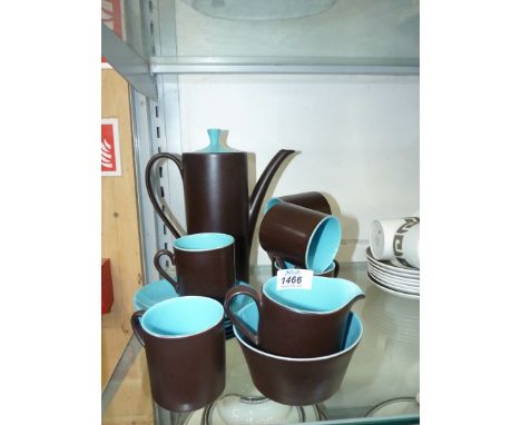 A Myott coffee set in matt chocolate brown having bright blue interior; six place setting with milk jug and sugar bowl.