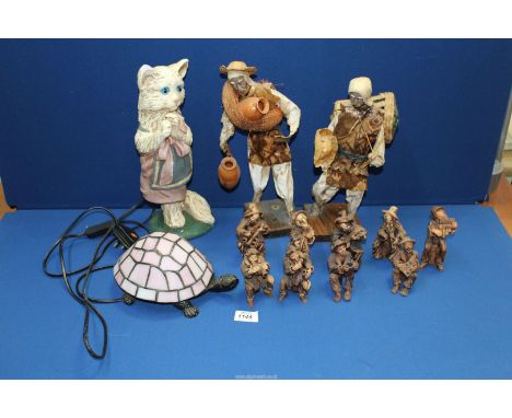 A quantity of miscellaneous figures including; musicians, tribal water carrier, a chalk figure of a cat having blue glass eye