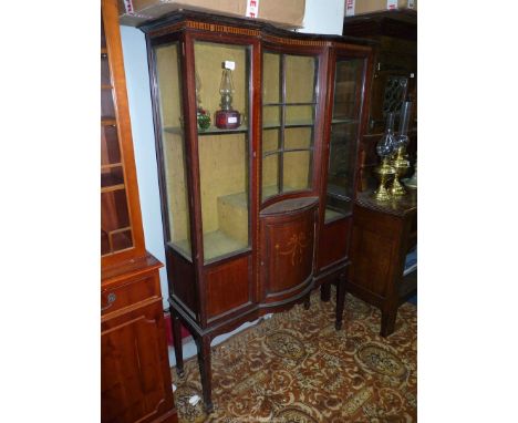 A circa 1900/1910 display cabinet having an inlaid decorated bowed central section cupboard with * backed glazing over the gl