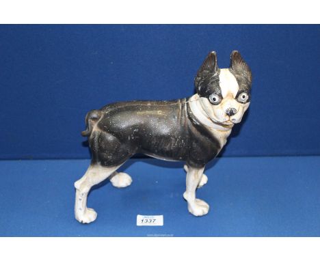A heavy cast metal model of a black and white Dog, 10" high.
