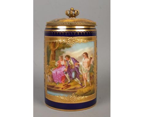 A Vienna porcelain tankard with cobalt blue ground, gilt decoration and hand painted classical scenes. The main panel after A