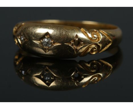 An 18ct diamond ring with star mounts. Size N, 3.1g.  One diamond is missing.