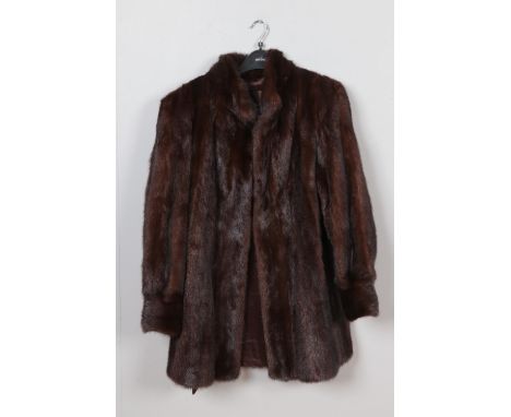 A vintage dark brown mink coat with embroided design to inner fabric.  