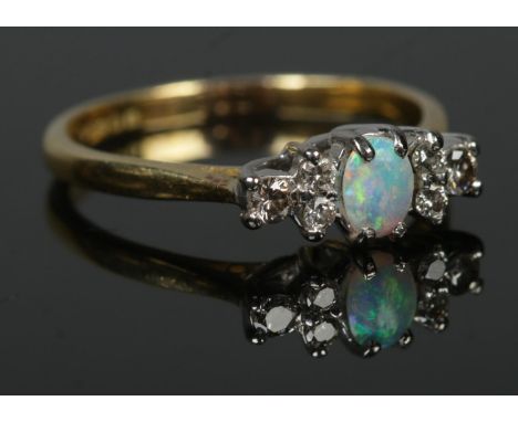 An 18ct gold, opal and diamond ring. Size N. 2.95g.  